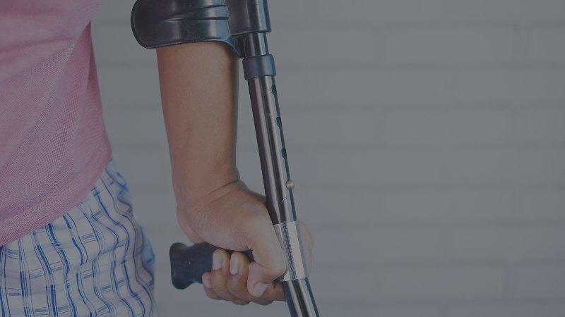man with a single arm crutch